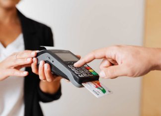 hand holding a credit card terminal