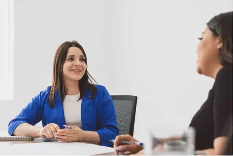 2 women having a conversation at work