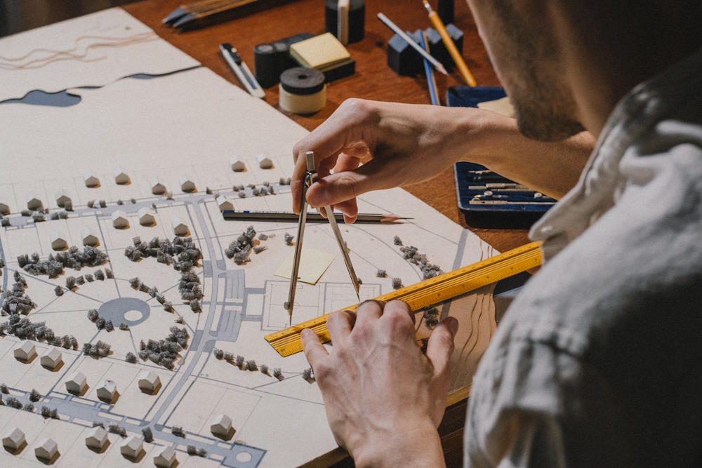 Image by Ron Lach via Pexels - Architect working with architectural model
