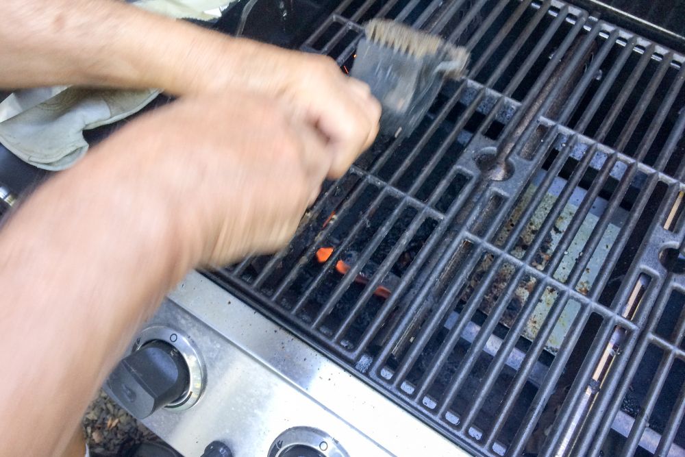 Image via Canvas - barbecue cleaning with brush