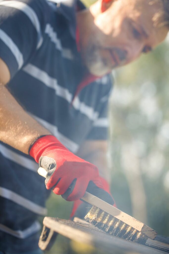 Image via Canvas - barbecue cleaning with large brush