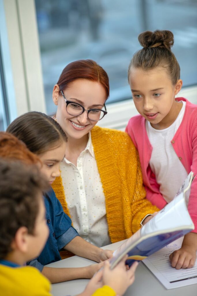 Image via Canvas - foreign teacher surrounded by children