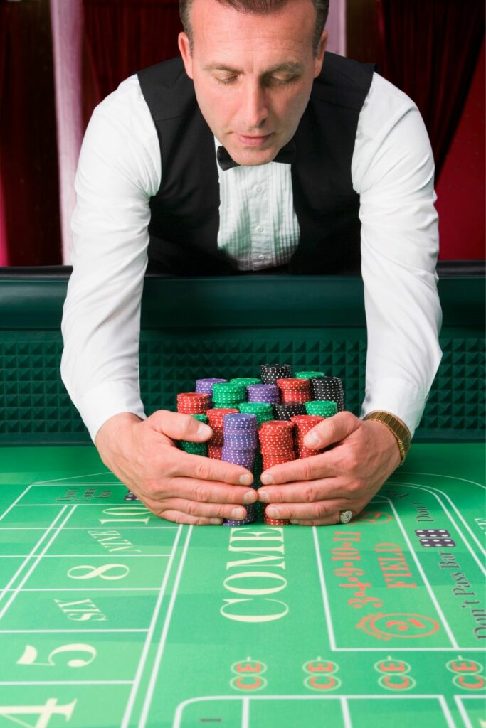 Image via Canvas - roulette dealer holding chips