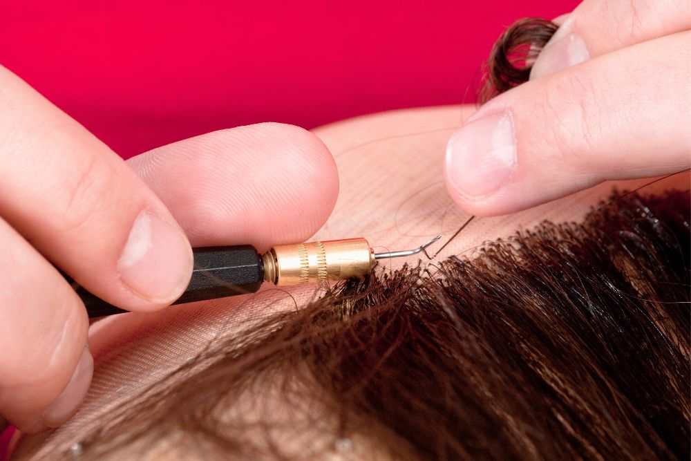 Image via Canvas - wig maker adding hair